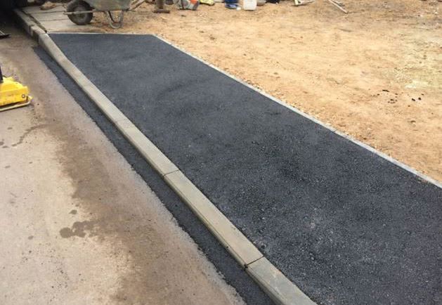 New commercial vehicle crossover with fresh tarmac and kerb edging by Drop Kerbs UK